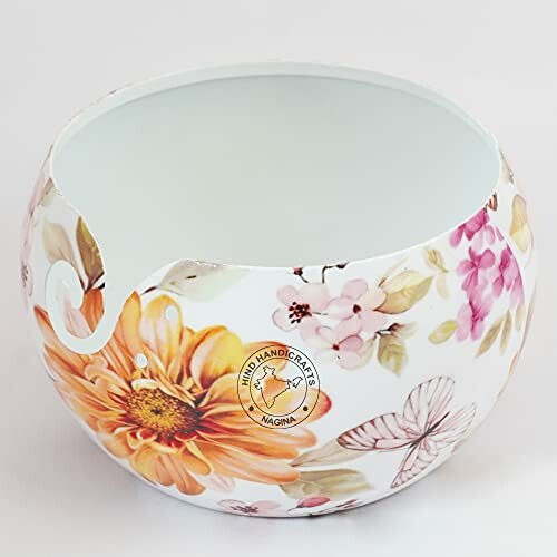 Floral ceramic yarn bowl with butterfly design.